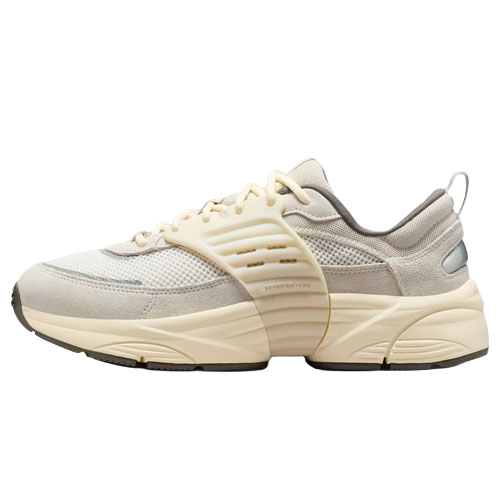 A beige and gray athletic sneaker with mesh and suede detailing, featuring a thick, sculpted sole for support and cushioning.