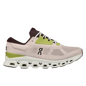 A pink and green athletic shoe featuring a breathable mesh upper and a distinctive sole with circular cutouts.