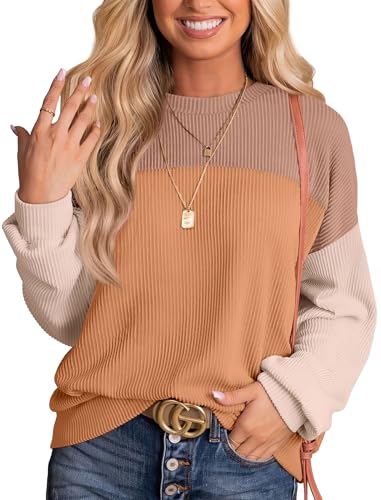 A woman wears a loose-fitting colorblock top with cream, terracotta, and brown hues, a ribbed pattern, and long sleeves.