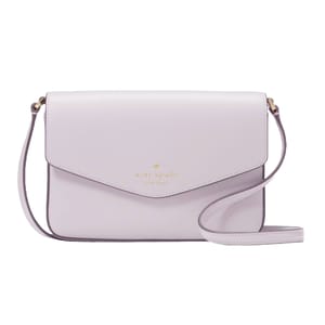 A light purple crossbody bag with a flap closure and a strap, featuring the Kate Spade New York logo in gold lettering.
