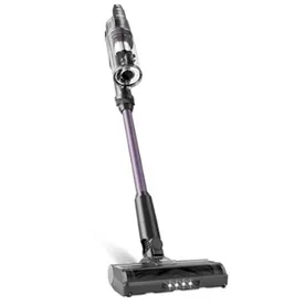 A cordless stick vacuum cleaner with a transparent dustbin and LED lights on the floor head, featuring a purple and black design.
