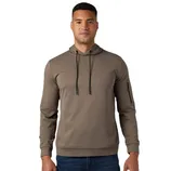A man wears a brown hoodie with black drawstrings and a zippered pocket on the sleeve, paired with blue jeans.