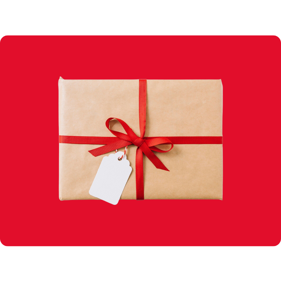 A gift wrapped in brown paper with a red ribbon and a blank white tag is centered on a red background.