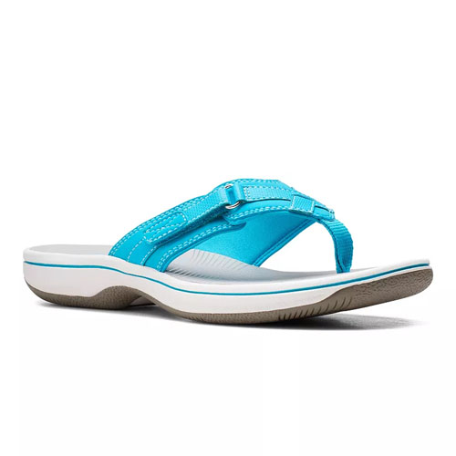 A turquoise thong sandal with a contoured white sole and textured brown outsole for traction. Features adjustable straps and visible stitching for style and durability.