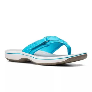 A turquoise thong sandal with a contoured white sole and textured brown outsole for traction. Features adjustable straps and visible stitching for style and durability.