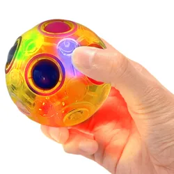 A colorful, translucent puzzle ball being held in a hand, featuring multiple circles with varying colors and glowing lights.