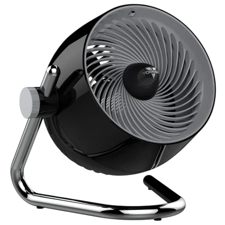 A black and silver tabletop fan with a circular design, featuring a tiltable head for adjustable airflow and a sturdy metal frame.
