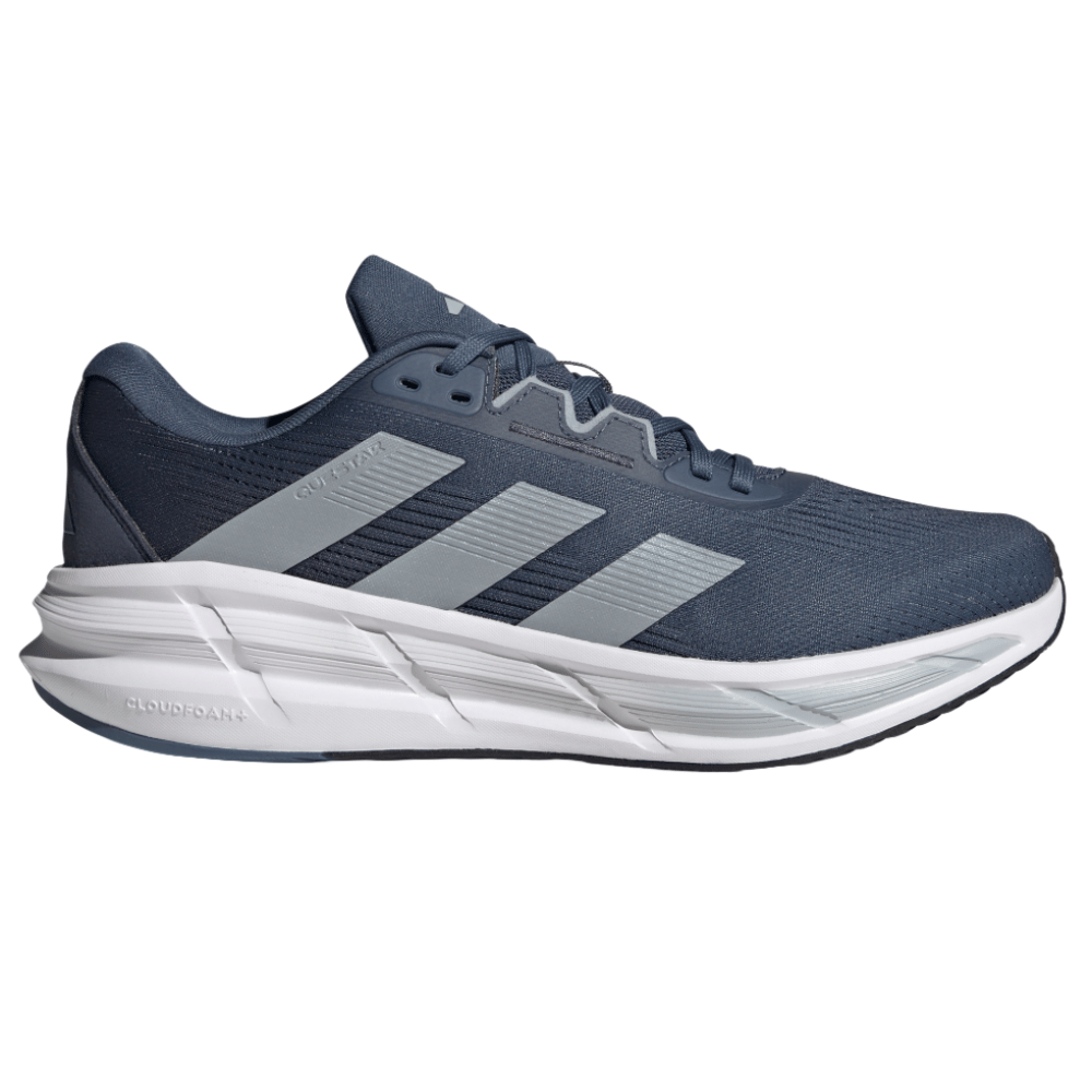 A dark blue athletic shoe with grey stripes, featuring a cushioned, white Cloudfoam sole for comfort.