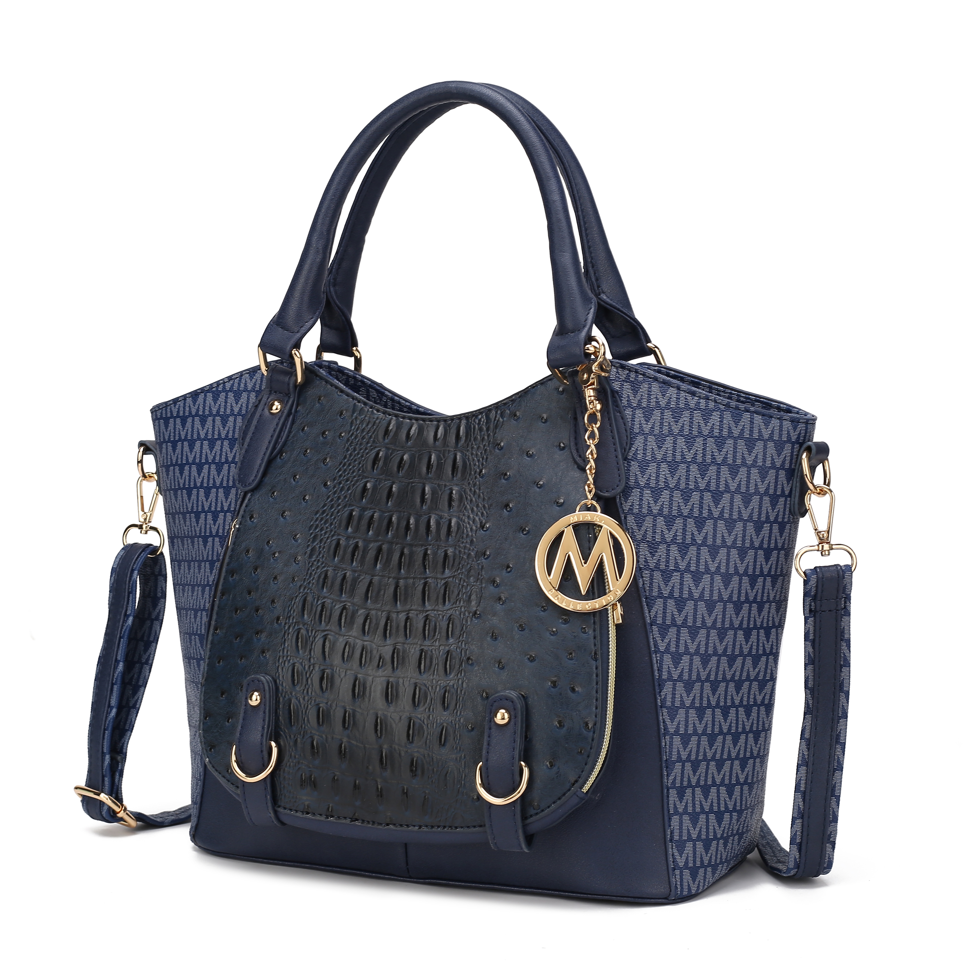 A navy-blue handbag featuring a central textured black panel, gold hardware, an \“M\“ charm, and a detachable crossbody strap. The sides display a repeating \“M\“ pattern in lighter blue.