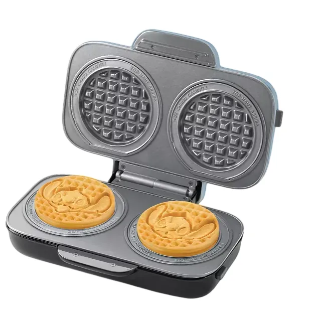 A double waffle maker featuring designs from Disney's \“Lilo & Stitch,\“ with two round waffles imprinted with Stitch's face. The device has a decorated lid showcasing a sun and palm tree sketch.