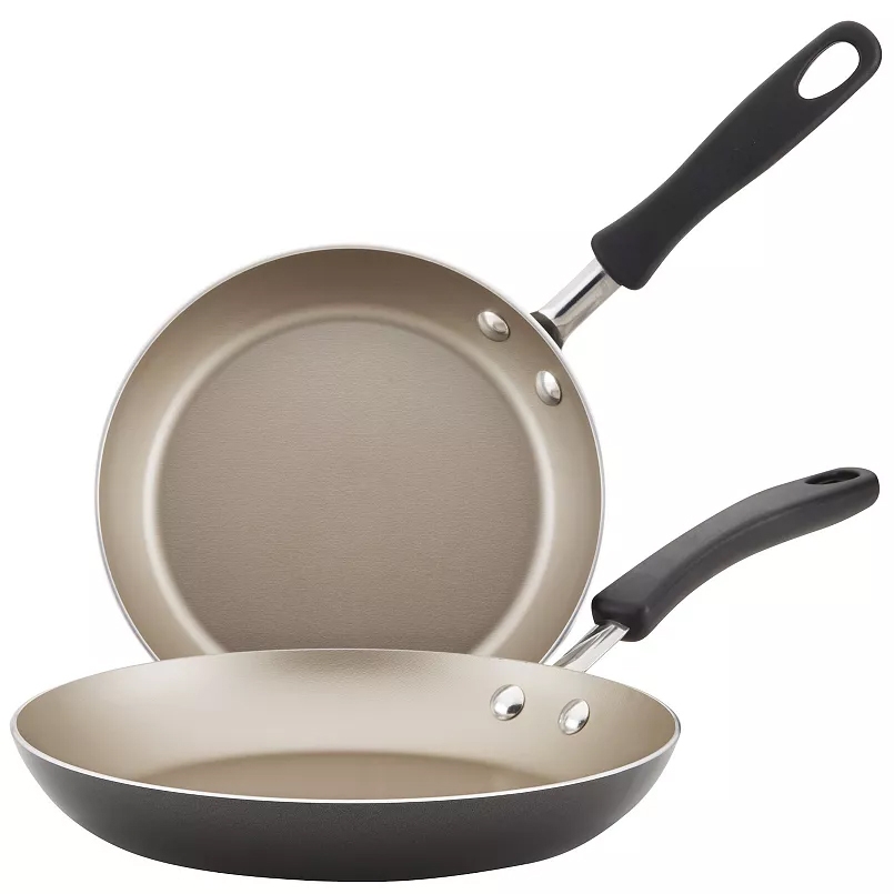 Two nonstick frying pans with black handles, featuring a beige interior and a dark exterior.