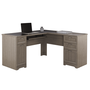 L-shaped wooden desk with a laptop, pen holder, and documents. Features multiple drawers and a pull-out keyboard tray.