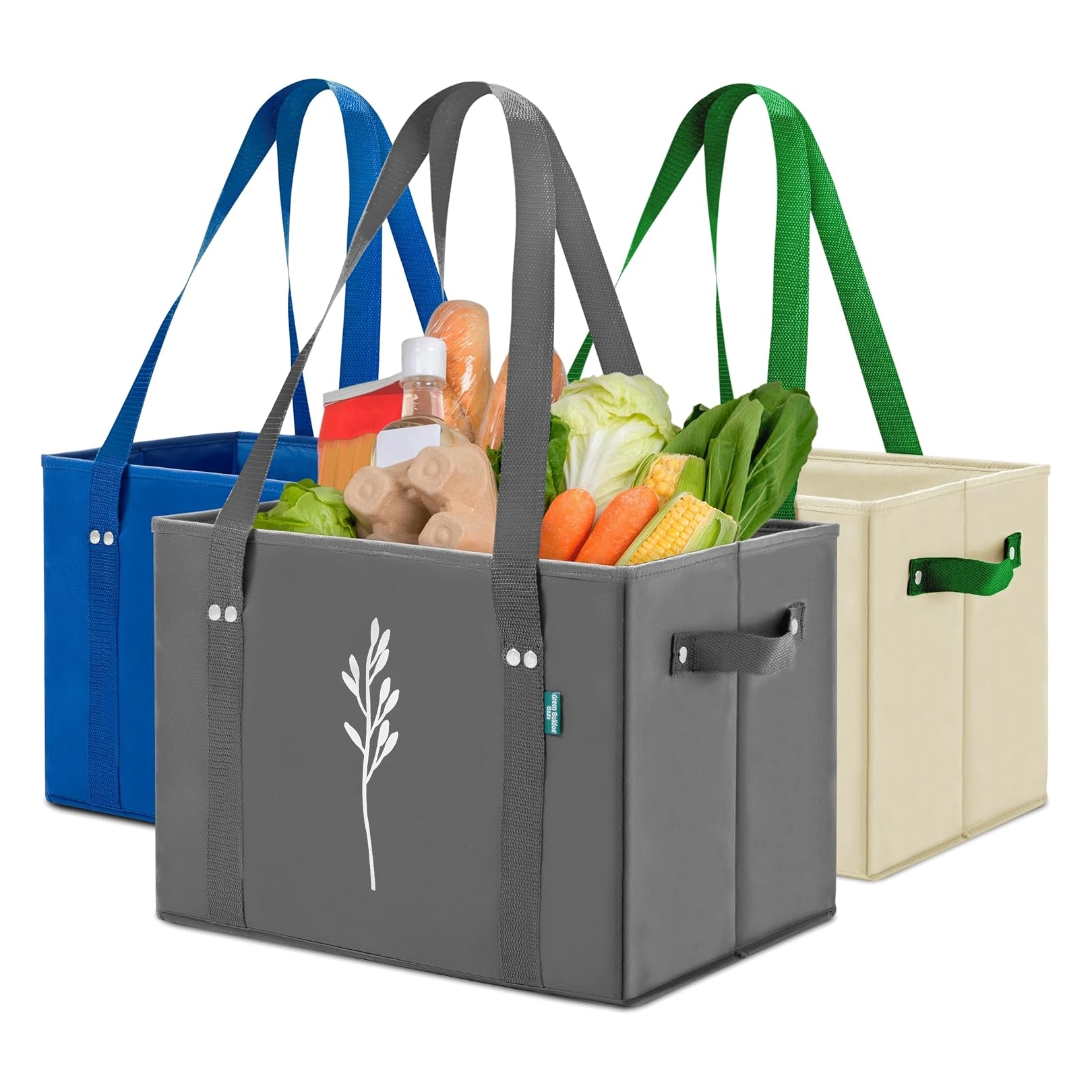 Three colorful reusable grocery bags are displayed, each with long straps and a leaf design, containing groceries like vegetables and packaged goods. Bags in blue, gray, and beige hues with matching handles are visible.