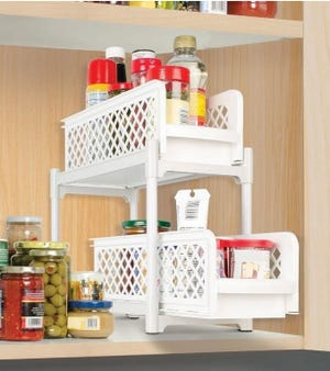 A two-pack of white, two-tiered sliding cabinet organizers with a lattice design, used for storing and organizing kitchen items on shelves.