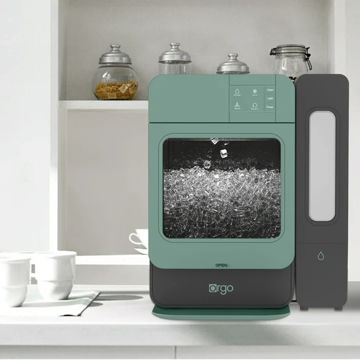 A countertop dishwasher in teal color with a clear window, next to a sleek black water purifier.