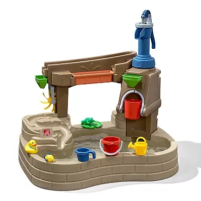 A children's water play table featuring a pump, various basins, toy ducks, and colorful cups and buckets.