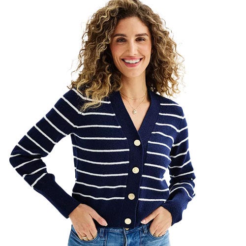 A woman wearing a blue and white striped cardigan.