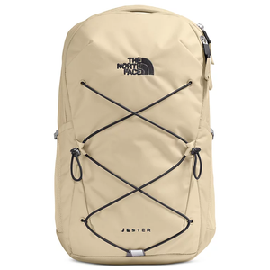 A beige North Face Jester backpack with black bungee cords on the front, featuring the brand logo and name embroidered on the upper and lower areas.