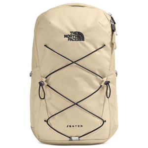 A beige North Face Jester backpack with black bungee cords on the front, featuring the brand logo and name embroidered on the upper and lower areas.