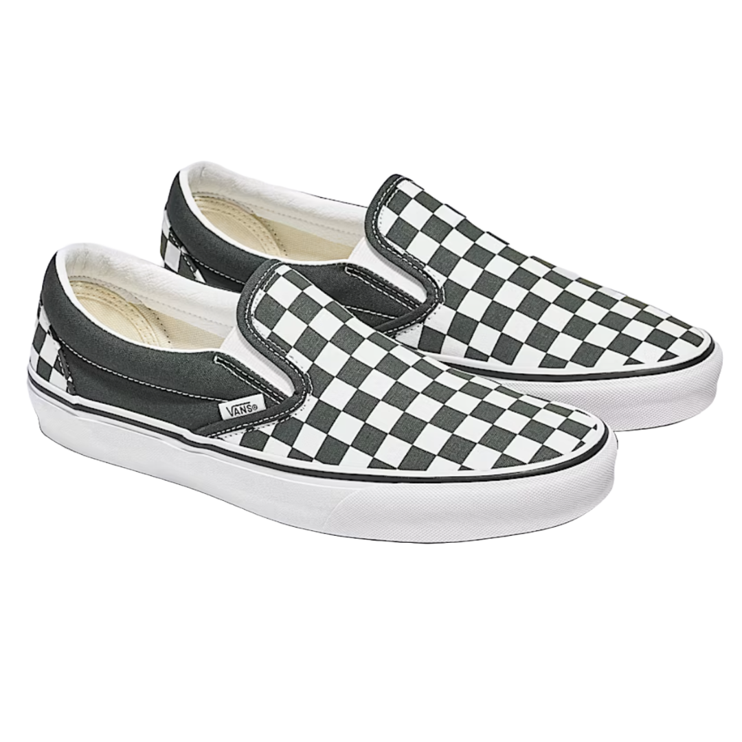 Black and white checkered slip-on shoes with white soles, branded \“Vans\“ on the side tag.