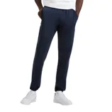 A man is wearing a white Champion t-shirt, navy jogger pants, and white sneakers, posing against a plain background.