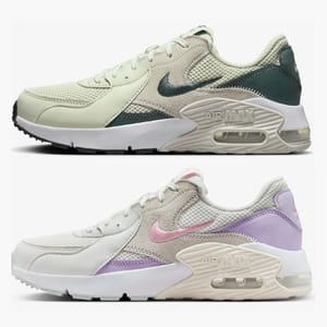 Two pairs of Nike Air Max 90 sneakers, one in a green and cream colorway, the other in white with pink and purple accents.
