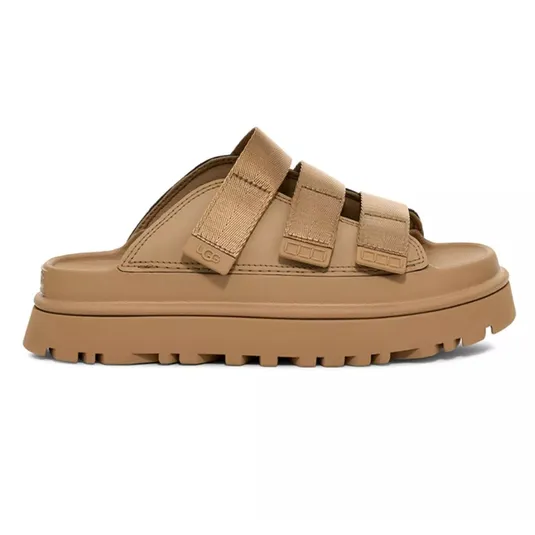 Tan sandal with three adjustable straps and a chunky treaded sole, featuring a minimalist design.