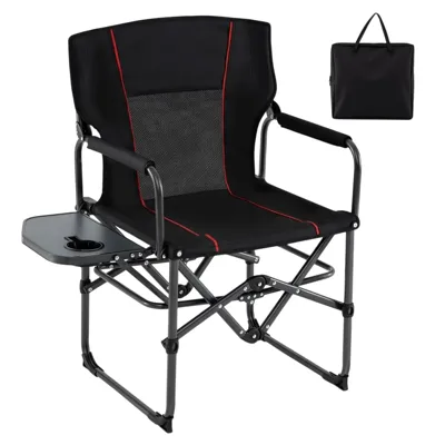 A black folding camping chair with red accents features a side table with a cup holder. It includes a carrying bag for easy transport.