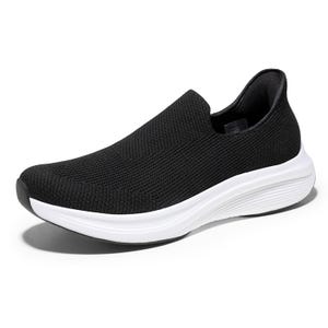 Black slip-on walking shoe with a breathable knit upper, cushioned white midsole, and black outsole; designed for comfort and ease of wear.