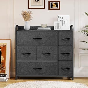 A dark gray fabric drawer dresser with four smaller drawers on the top row and four larger ones on the bottom, set in a black metal frame.