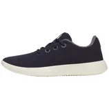 A dark blue casual sneaker with a textured fabric upper, white sole, and grey lining, featuring a lace-up design with eyelets.