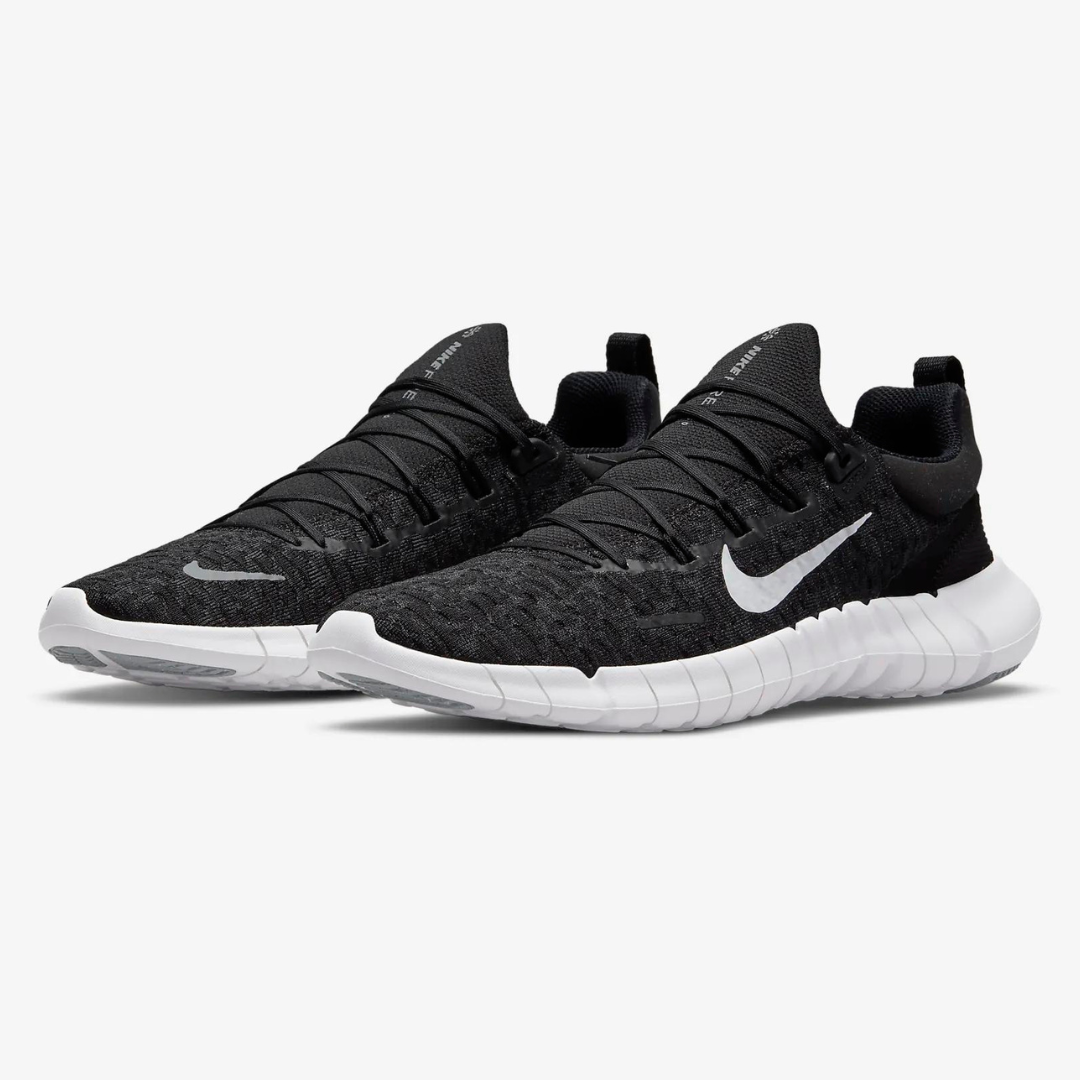 A pair of black Nike running shoes with a white swoosh logo and a white segmented sole.