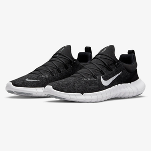 A pair of black Nike running shoes with a white swoosh logo and a white segmented sole.