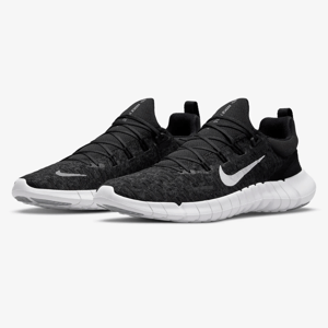 A pair of black Nike running shoes with a white swoosh logo and a white segmented sole.