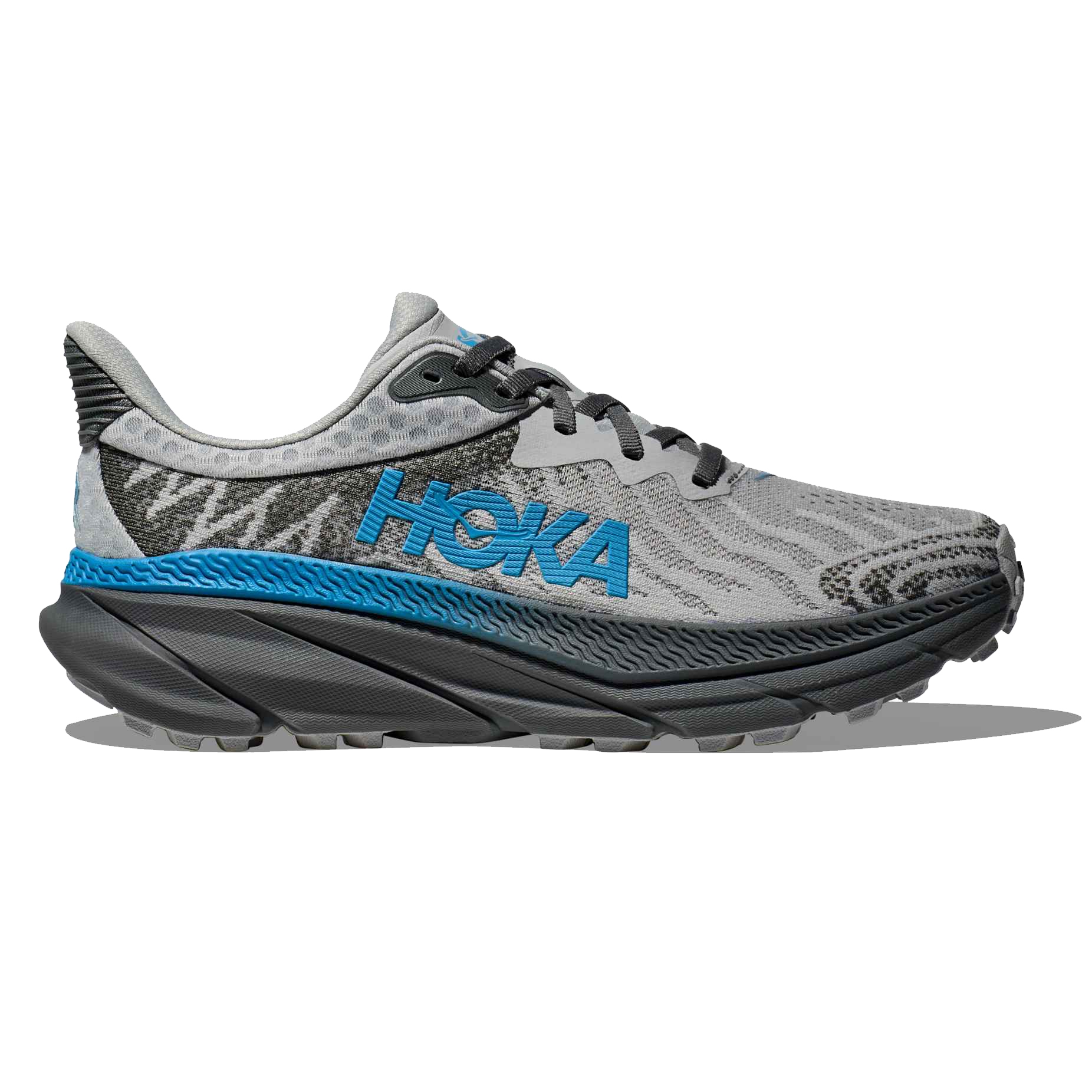 Hoka Women's Challenger 7 Shoes feature a gray and blue design with a textured pattern, a cushioned sole, and the Hoka logo on the side, ideal for trail running and cushion support.