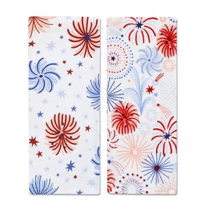 Two white towels featuring red, white, and blue fireworks and star patterns, suitable for festive occasions or patriotic themes.