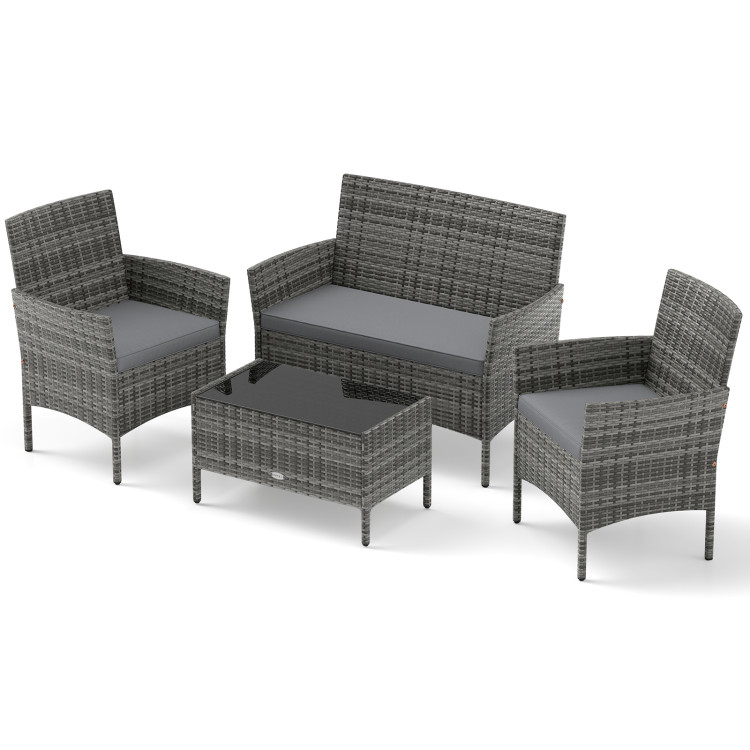 A 4-piece outdoor rattan furniture set featuring a loveseat, two armchairs with gray cushions, and a coffee table with a black glass top.