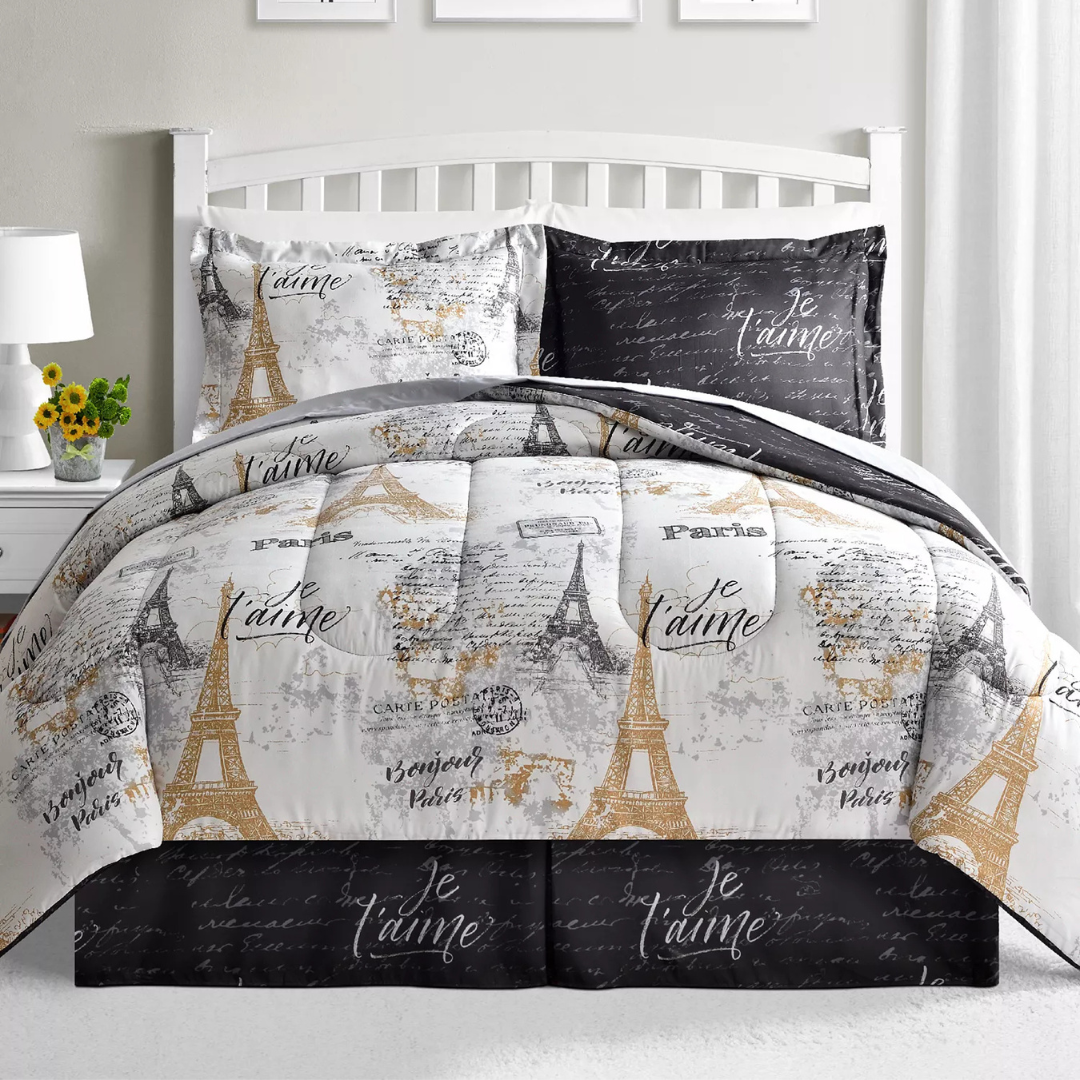 A bedding set with a Paris theme featuring designs of the Eiffel Tower and phrases like \“Je t'aime\“ and \“Bonjour Paris.\“ The color scheme includes black, white, and gold tones.