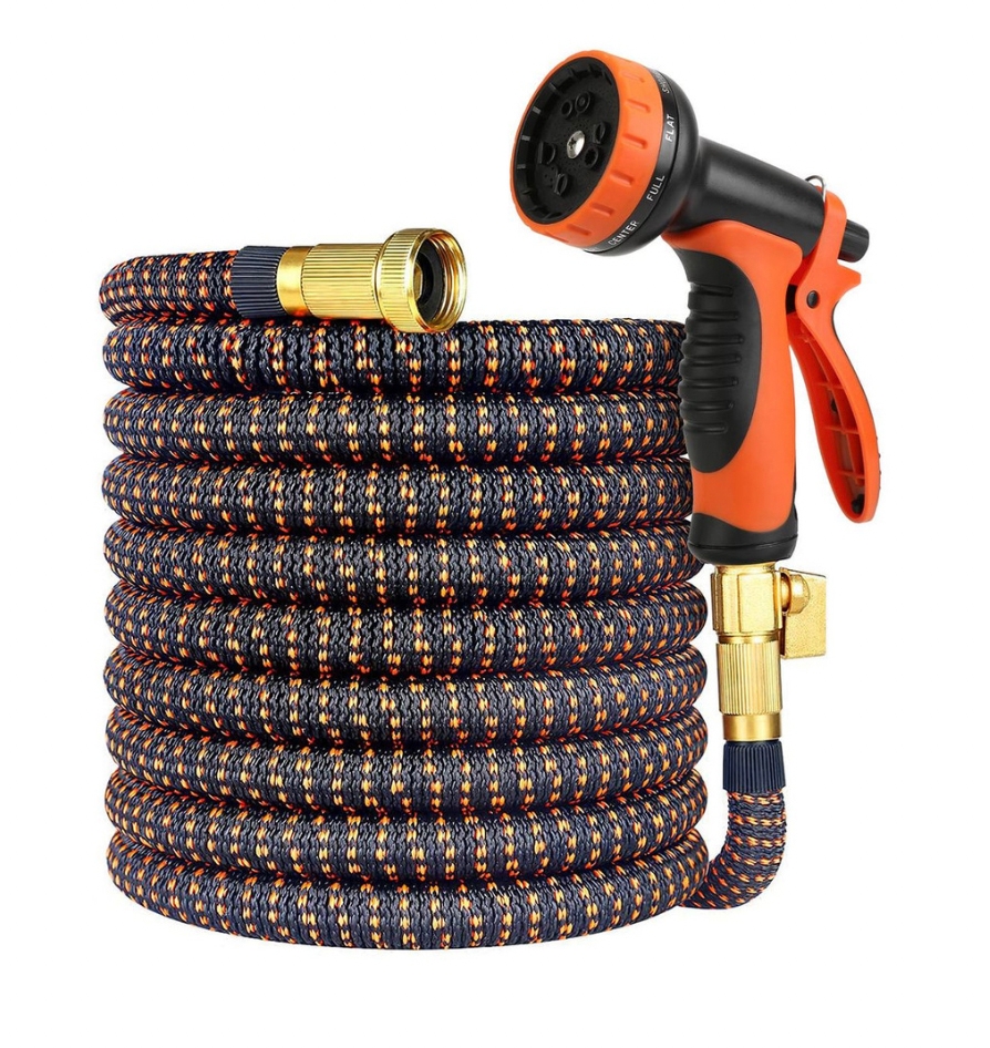 Expandable garden hose with an orange and black pattern, featuring brass connectors and an adjustable spray nozzle with multiple settings.