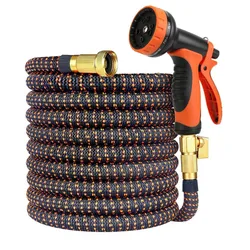 Expandable garden hose with an orange and black pattern, featuring brass connectors and an adjustable spray nozzle with multiple settings.