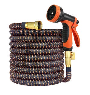 Expandable garden hose with an orange and black pattern, featuring brass connectors and an adjustable spray nozzle with multiple settings.
