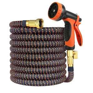 Expandable garden hose with an orange and black pattern, featuring brass connectors and an adjustable spray nozzle with multiple settings.