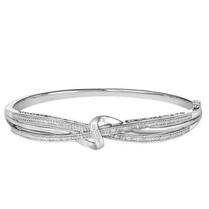 A silver-tone bangle bracelet featuring a twisted knot design with textured and smooth elements for added detail.