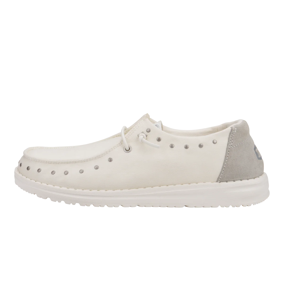 Wendy Star Studded Shoes are casual slip-ons featuring a white color with silver studs along the sides, light gray suede accents on the heel, and a white sole. They have lace detailing for added style.