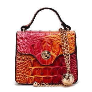 Brightly colored MKF Mini-Crossbody featuring a crocodile texture, gold chain strap, gold clasp, and a decorative gold ball accent.