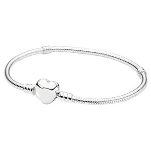 A sleek silver bracelet with a snake chain design, featuring a prominent heart-shaped clasp at its center.