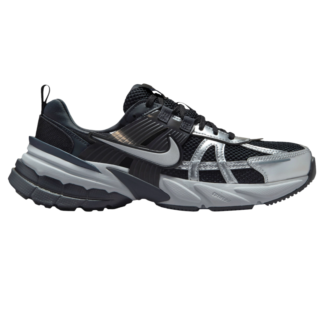 Black and silver Nike athletic shoe with mesh and synthetic materials, featuring a distinct swoosh logo and a thick sole for cushioning and support.