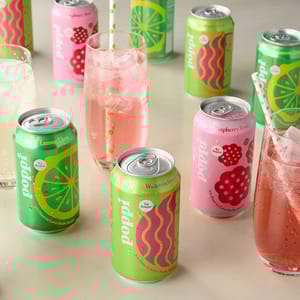 Variety pack of Poppi Prebiotic Soda, featuring colorful cans of Lemon Lime, Watermelon, and Raspberry Rose flavors, with each labeled as low sugar and served chilled in glasses with straws.