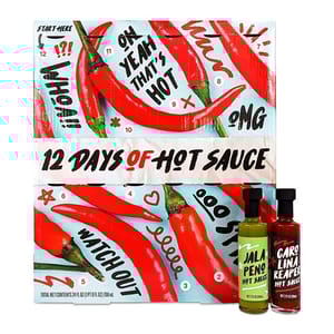 12 Days of Hot Sauce Advent Calendar features an assortment of hot sauces with illustrations of red chilies and phrases like \“Oh Yeah That's Hot.\“ Includes bottles labeled \“Jalapeño Hot Sauce\“ and \“Carolina Reaper Hot Sauce.\“