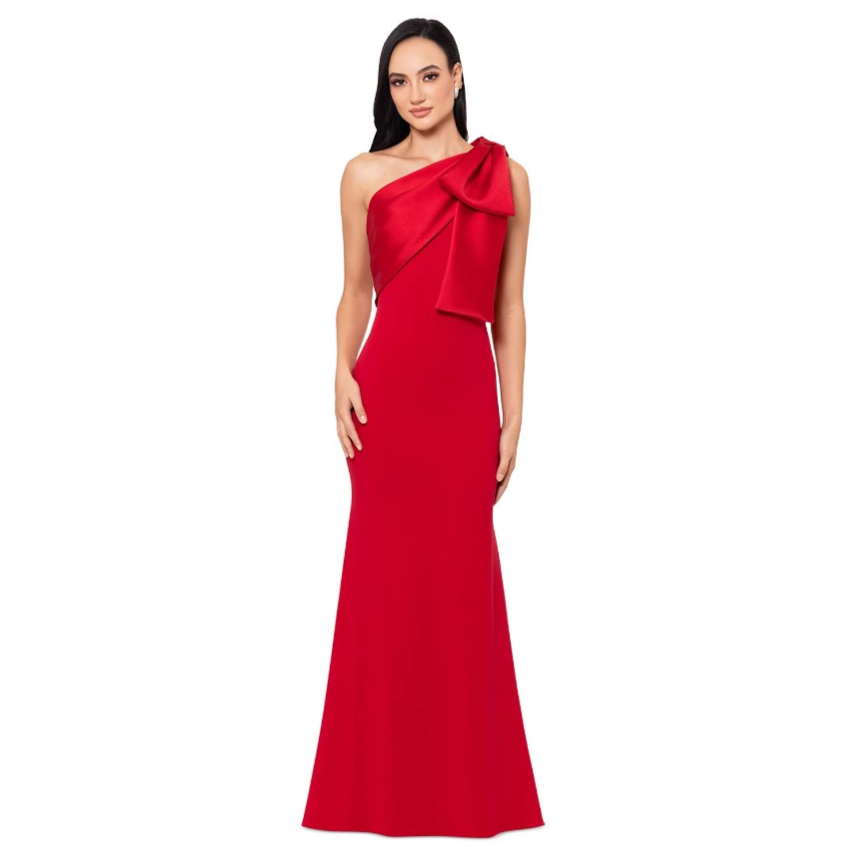Elegant, red, one-shoulder gown featuring a large bow detail on the shoulder, with a fitted silhouette that flares out gently at the hem.